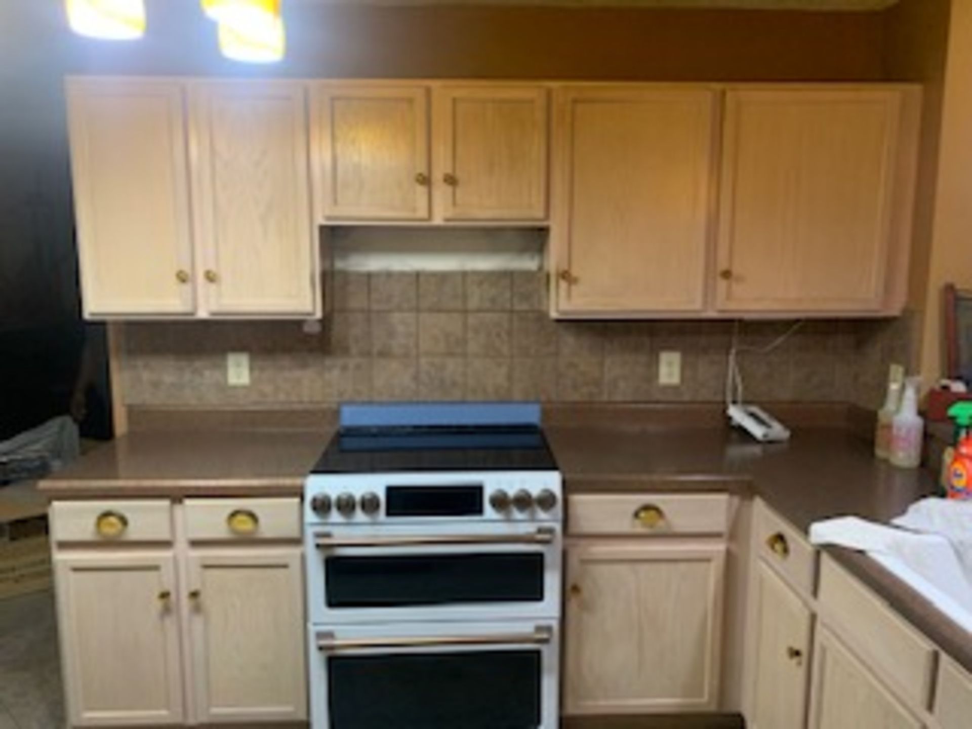 a kitchen with a stove , oven , cabinets and counter tops .
