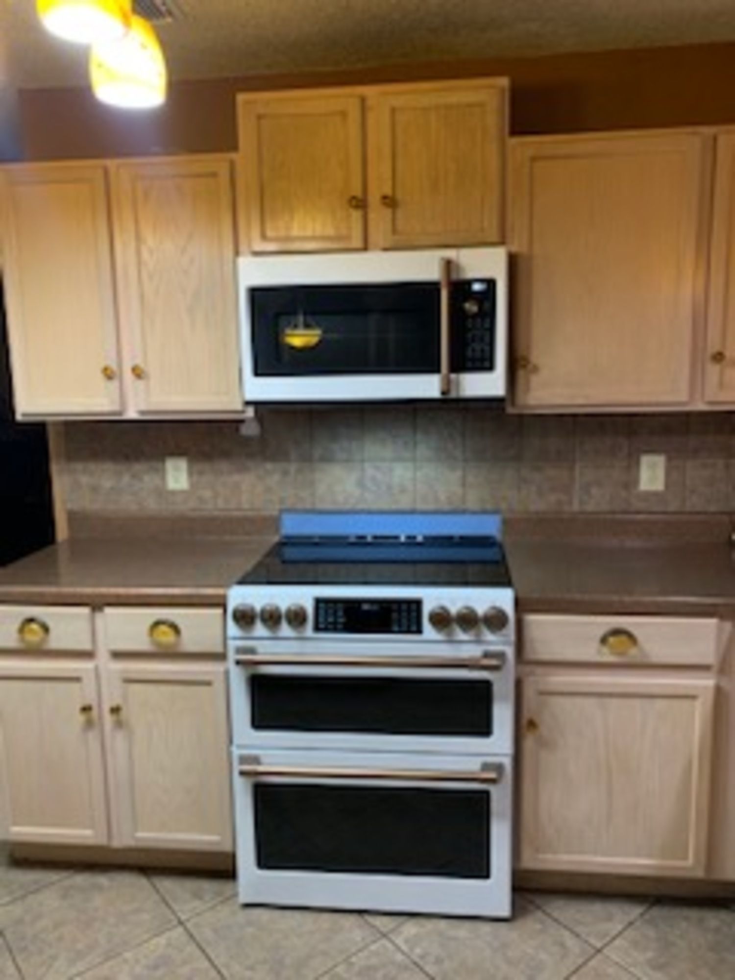 a kitchen with a stove top oven and a microwave