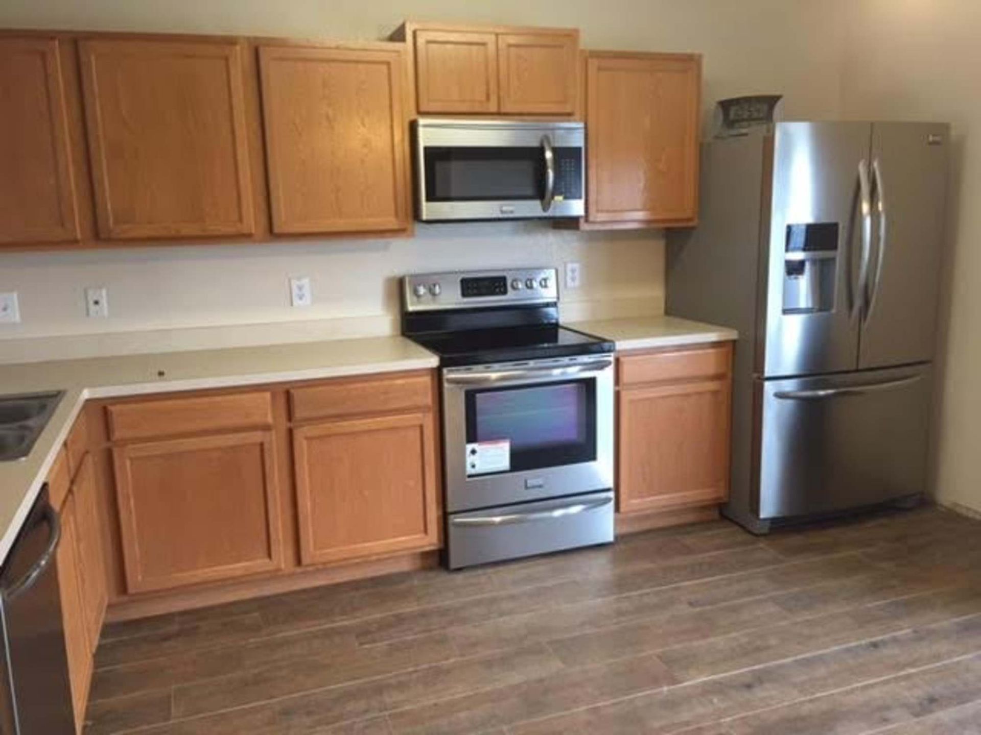 a kitchen with stainless steel appliances and wooden cabinets .