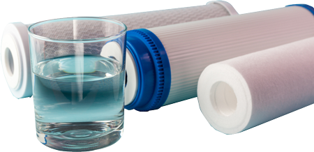 A Glass Of Water On The Background Of Filter Cartridges — Eureka Water & Filtration In Mount St John, QLD