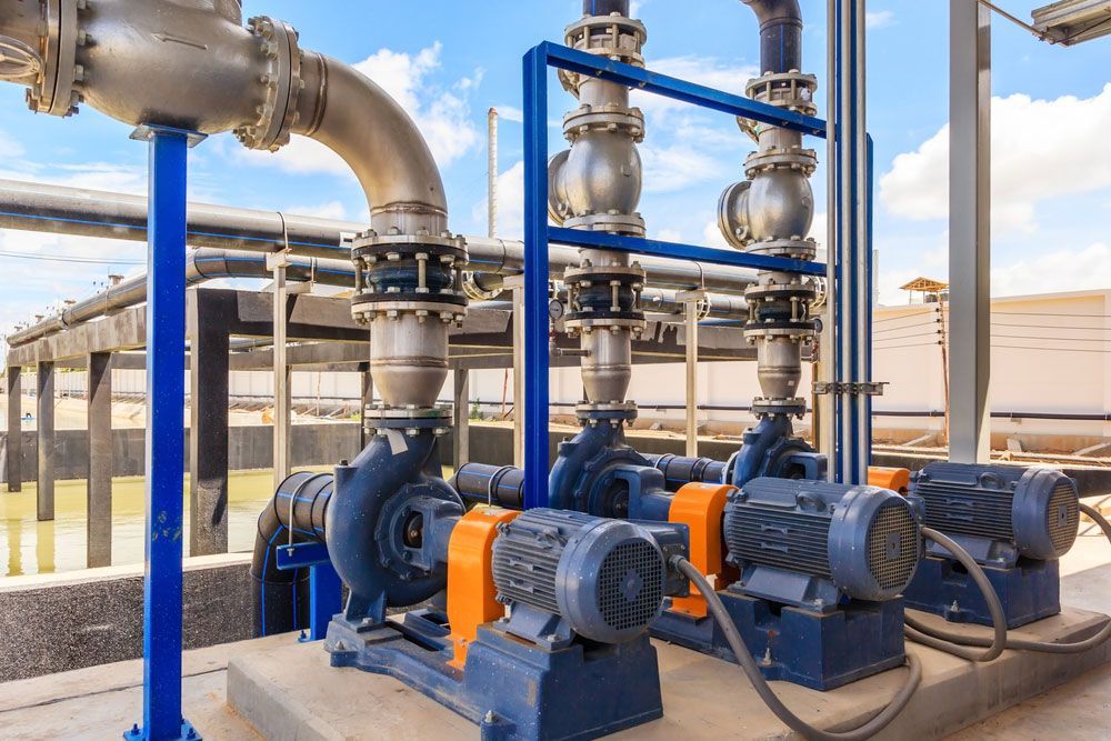 A Bunch Of Pumps Are Sitting Next To Each Other In A Factory — Eureka Water & Filtration In Mount St John, QLD