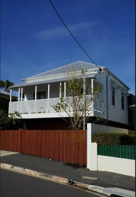White House With a Wooden Fence in Front of It — Wilson's House Restumping in Goonellabah, NSW