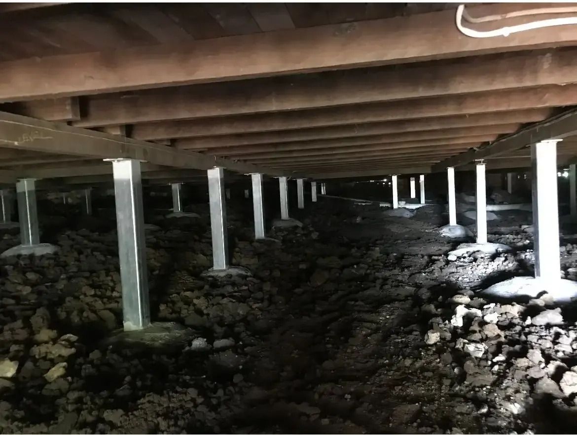 Yellow House With a Blue Roof is Sitting on Top of a Hill — Wilson's House Restumping in Bangalow, NSW