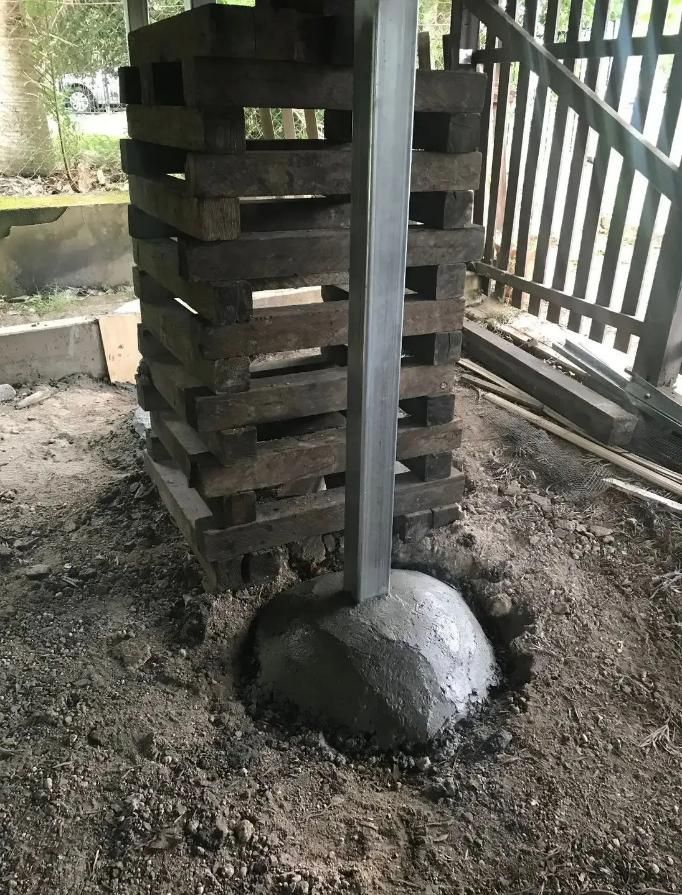 Yellow House With a Blue Roof is Sitting on Top of a Hill — Wilson's House Restumping in Goonellabah, NSW