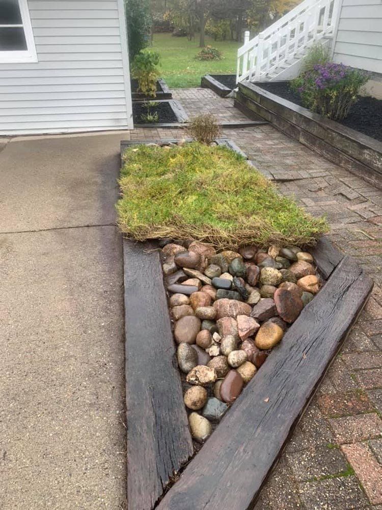 A brick wall is being built in front of a house. retaining wall