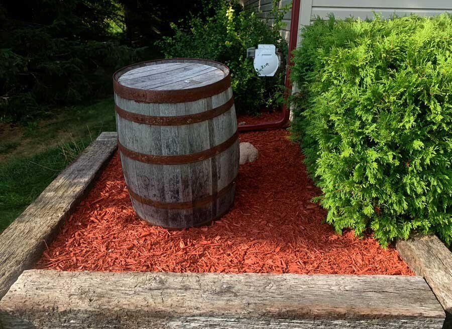 A brick house with a patio and a trailer parked in front of it.brick paver patio