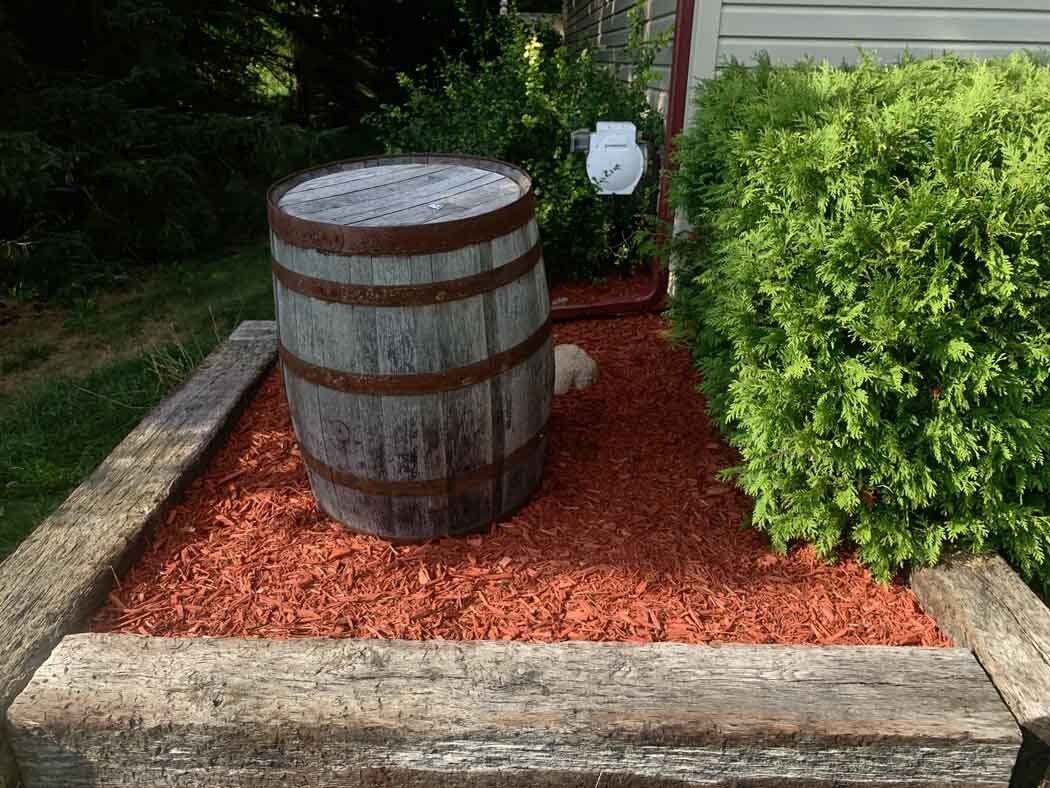 A gravel path leading to a house with a chain link fence. rock installation