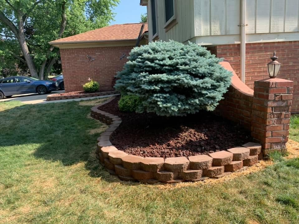 A person wearing a green sweatshirt that says atb construction services. rock. boulders