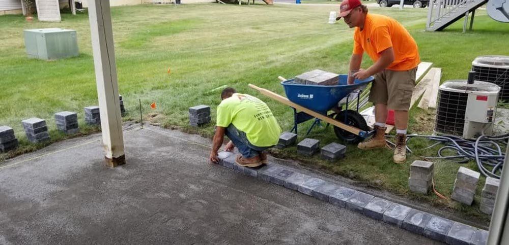 A before and after picture of a fire pit in a backyard. fire-pit