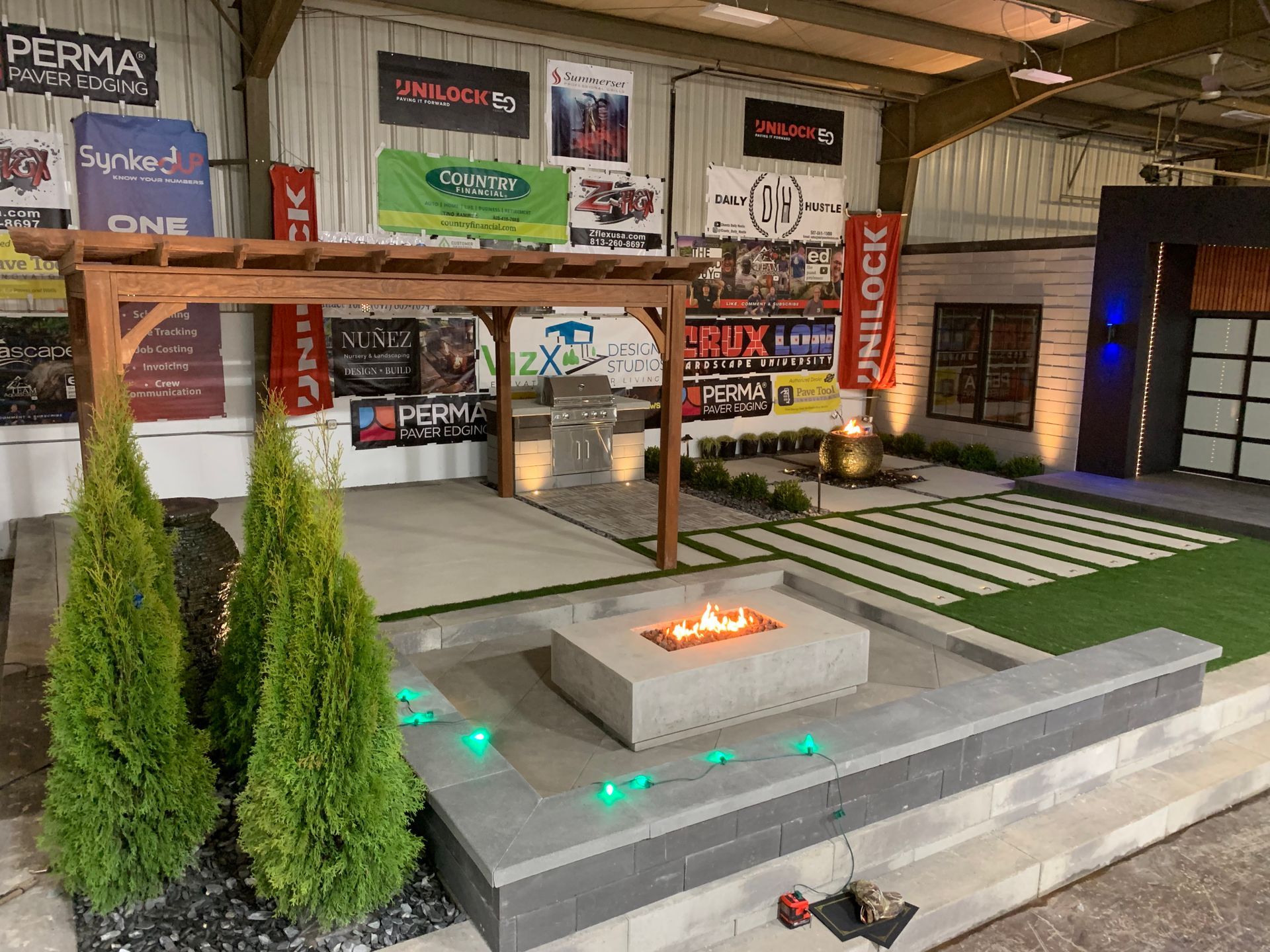 A house with a fire pit in front of it at night. outdoor living lighting