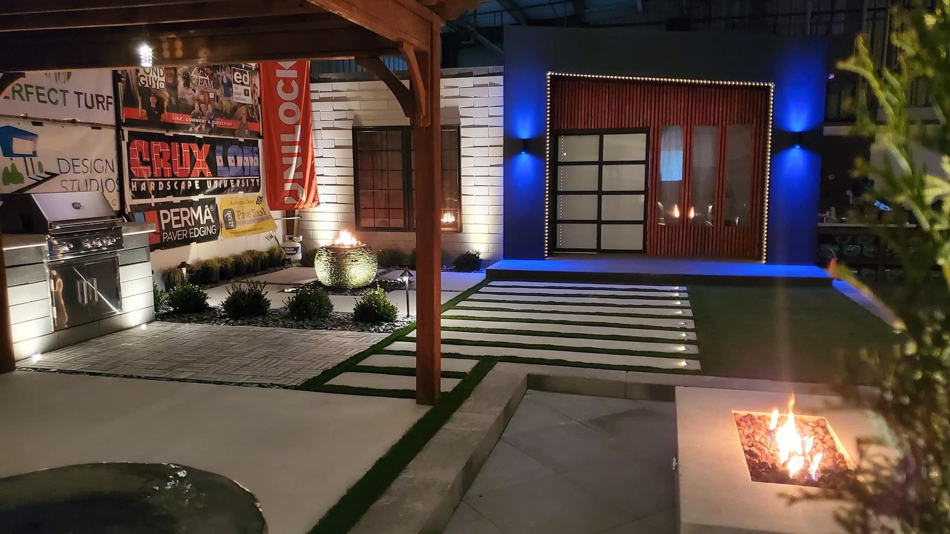 A house with a fire pit in front of it at night.outdoor living