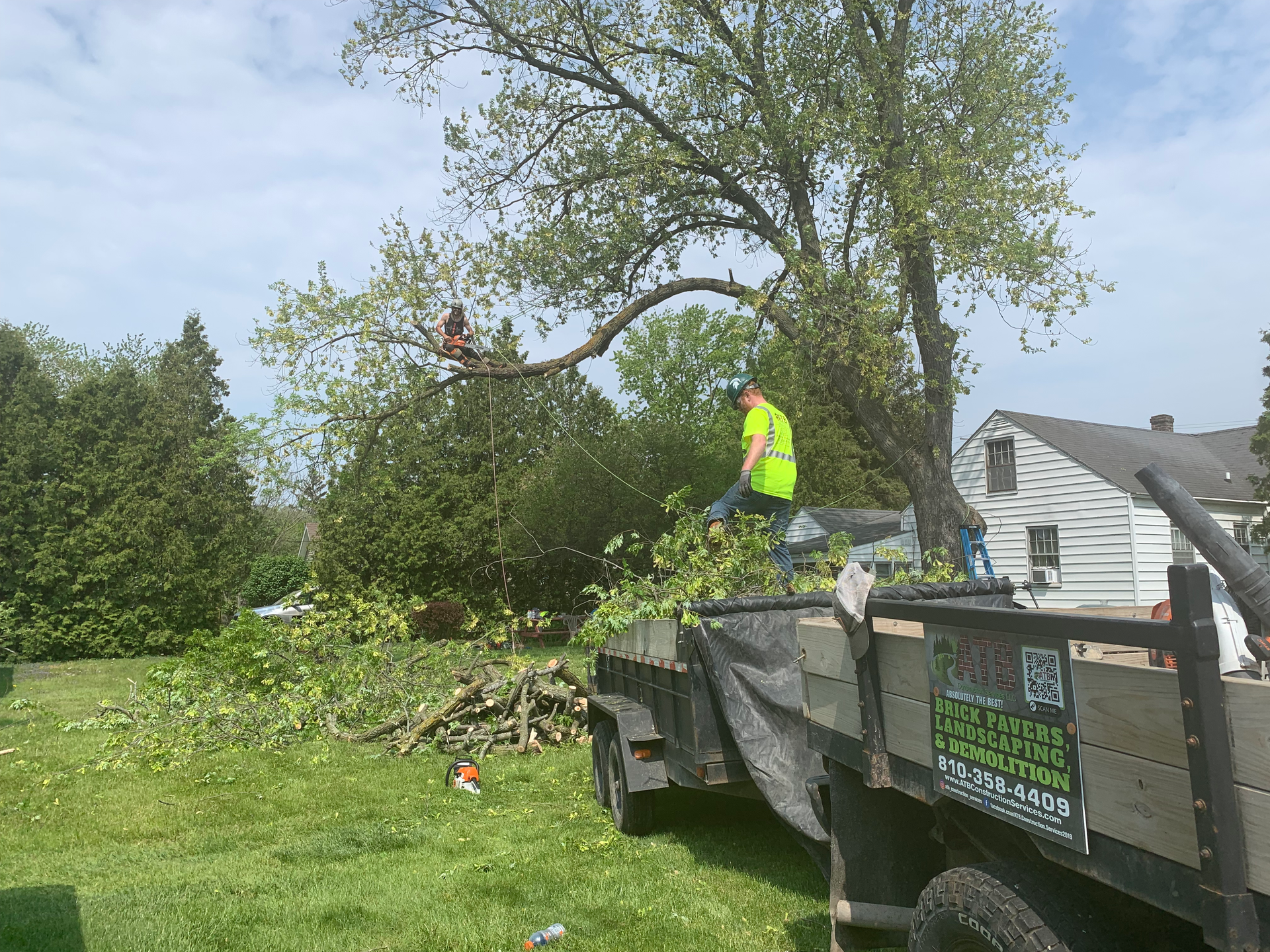 A shadow of a person is cast on the ground in front of a house. GRADING.