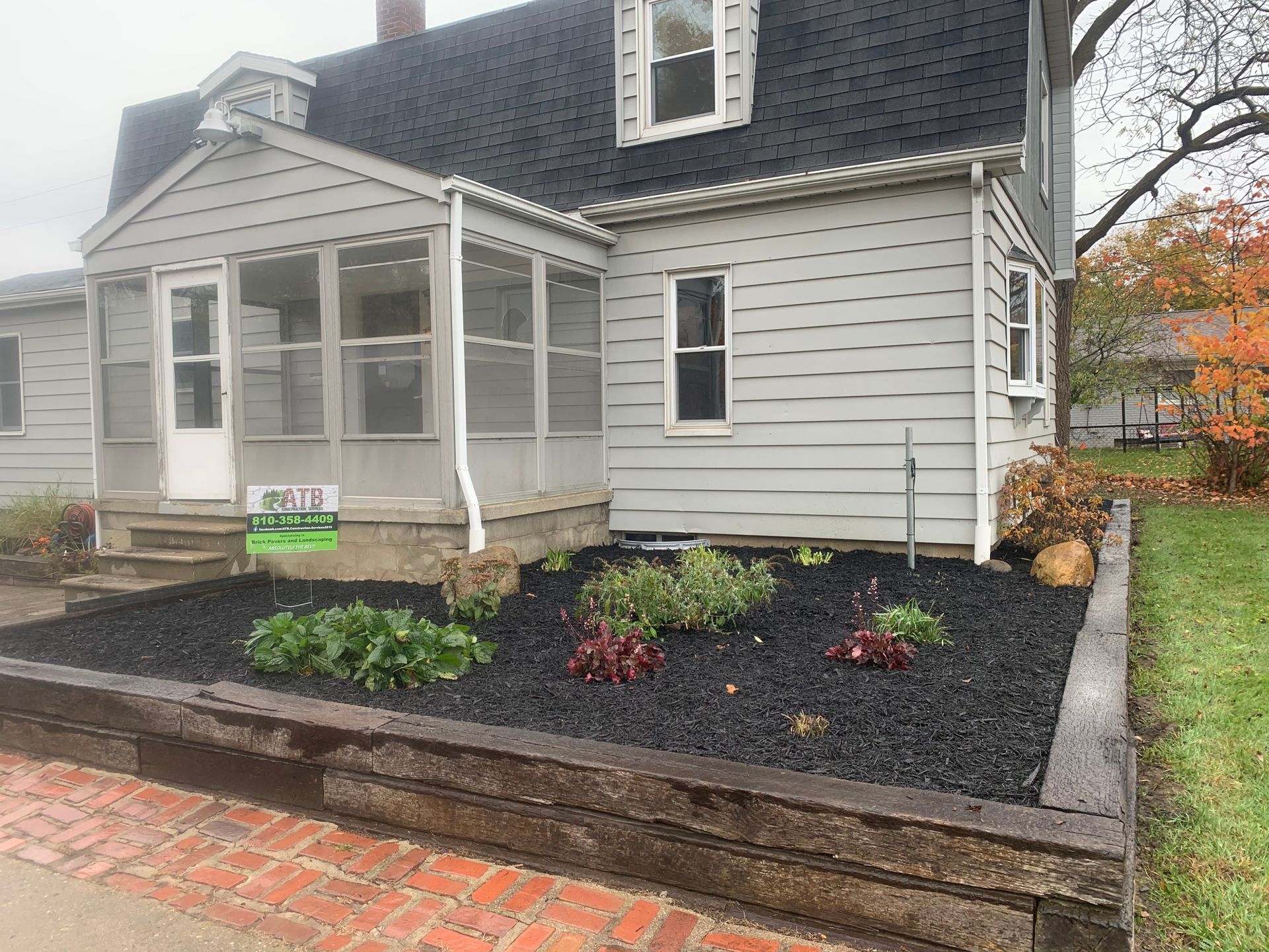 A truck and a bulldozer are driving through a muddy field.mulch installation.