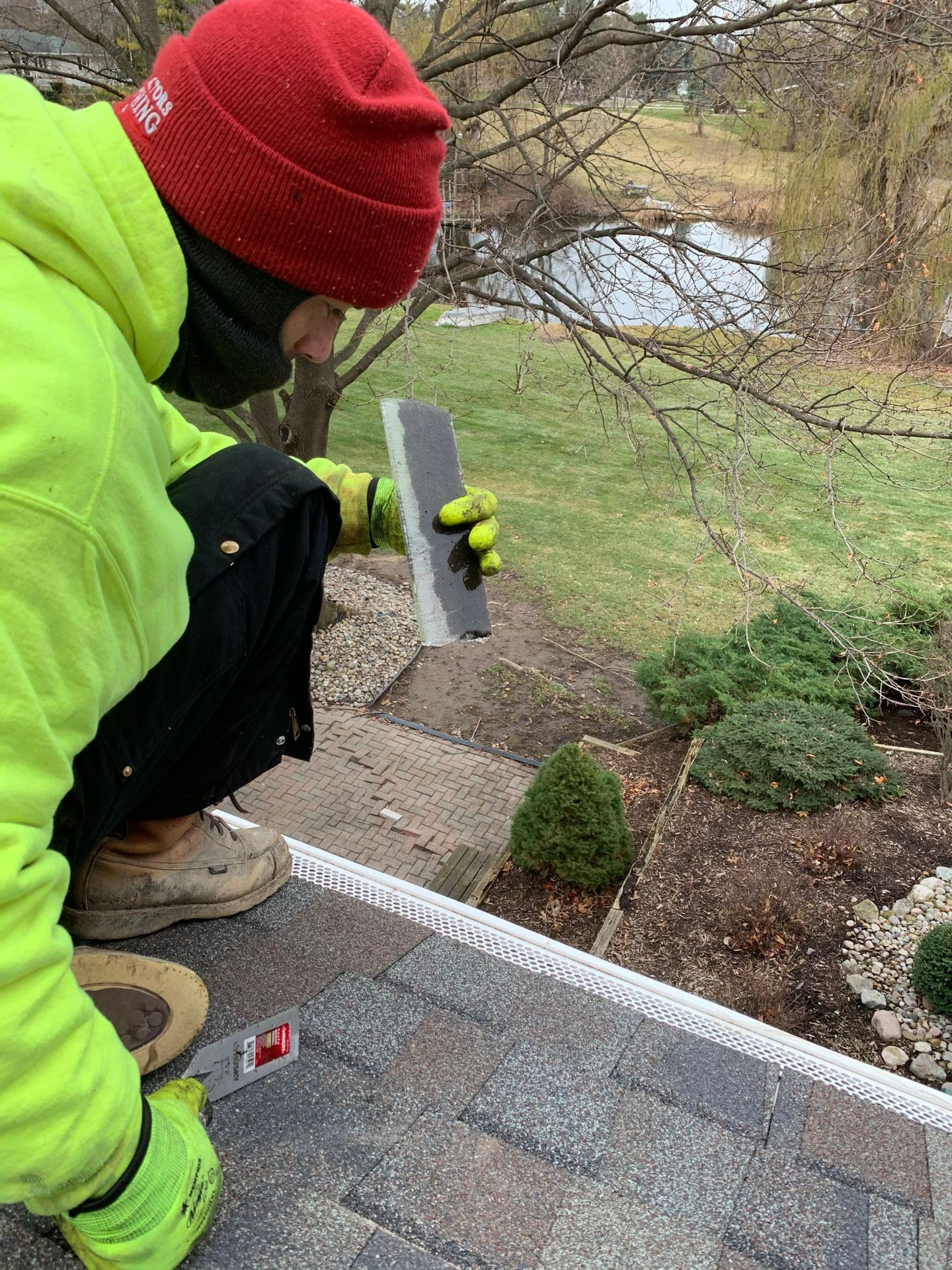 A fire pit in front of a sign that says perma paver edging. water feature. lighting