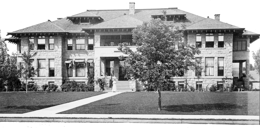 A black and white photo of a large house