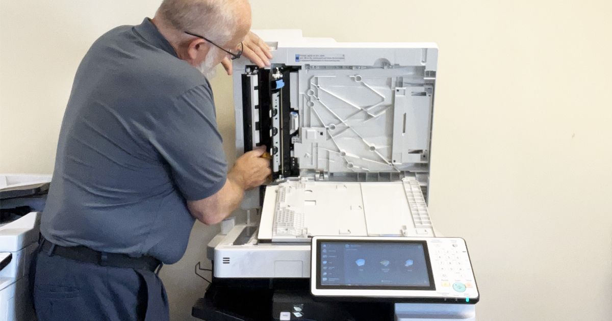 Tom Banks technician fixing copiers