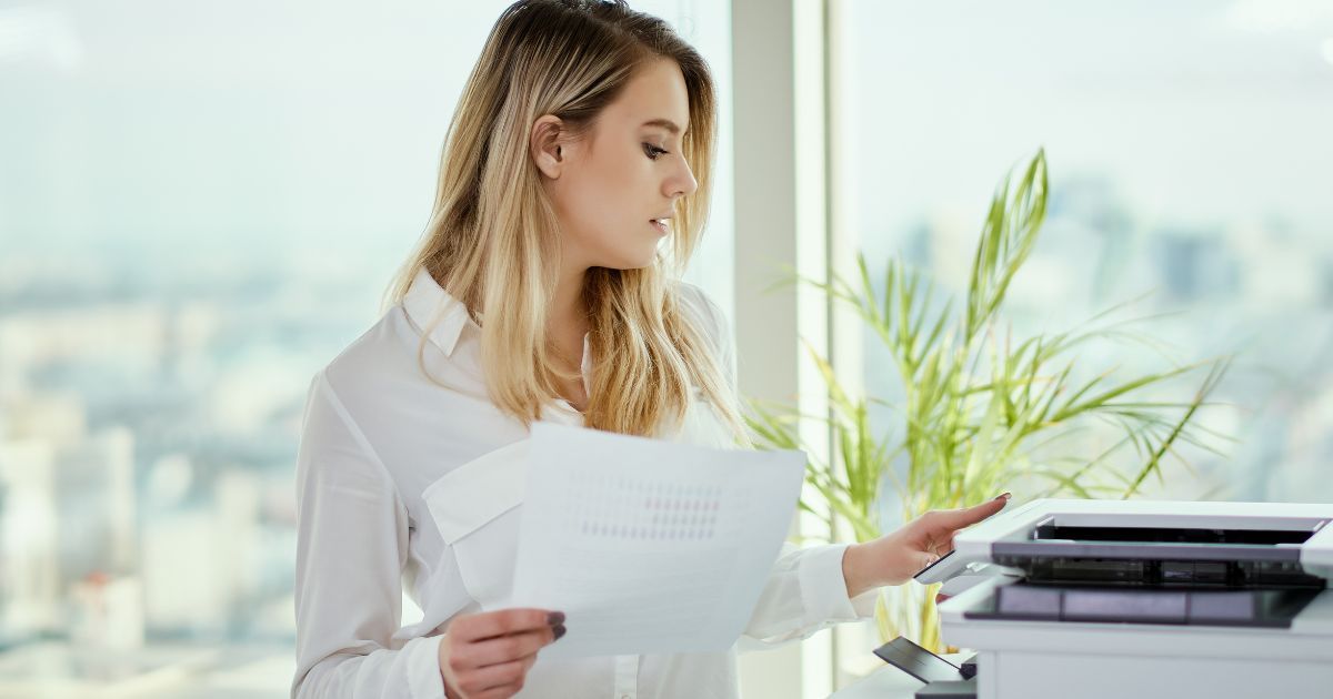 Man and woman using a multifunction printer