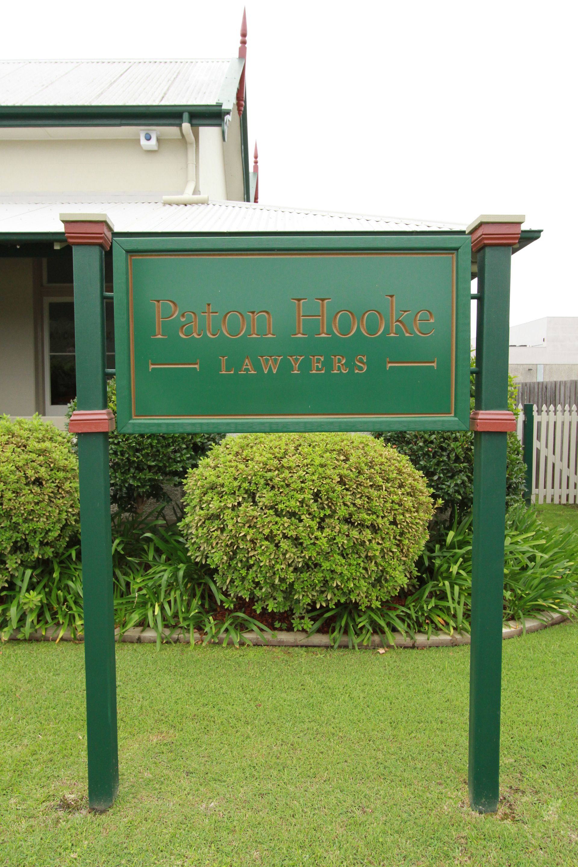 A White House With a Green Roof and a White Picket Fence — Paton Hooke Lawyers & Conveyancers In Taree, NSW