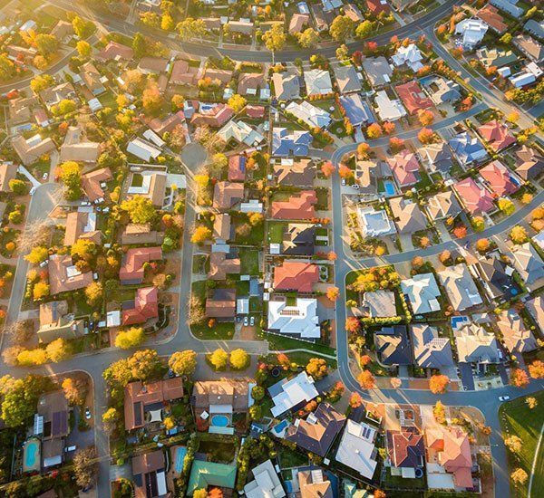 An Aerial View of a Residential Area With Lots of Houses and Trees — Paton Hooke Lawyers & Conveyancers In Taree, NSW