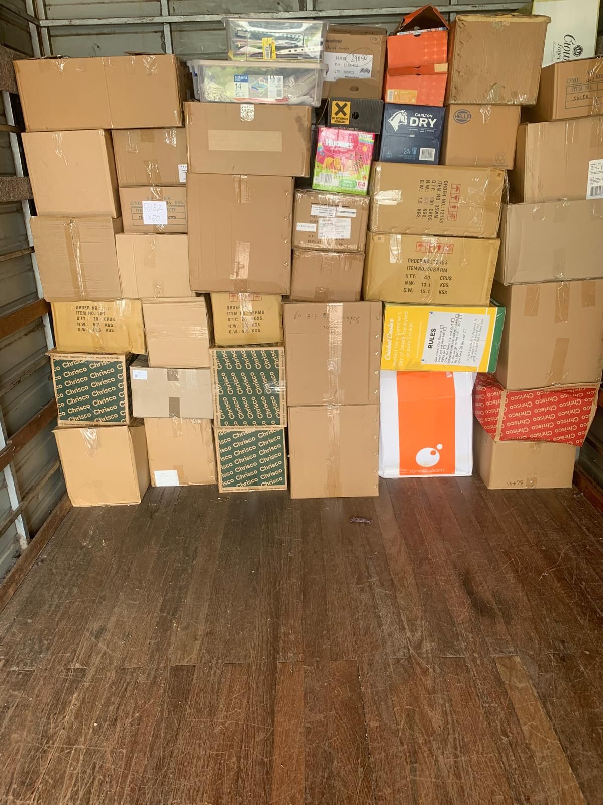 A truck filled with lots of boxes on the back of it.