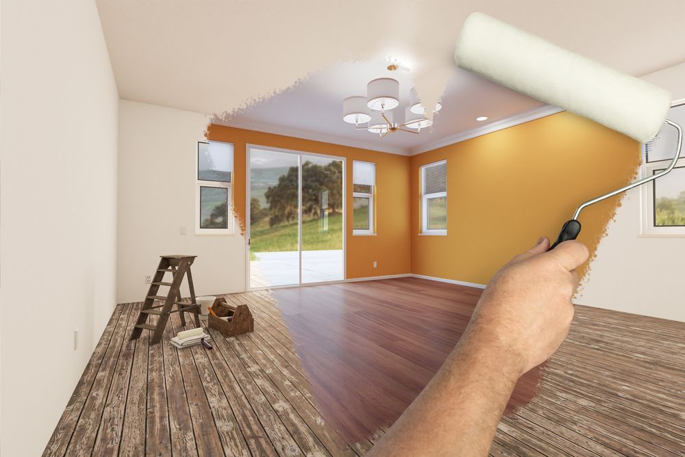 A person is painting a room with a paint roller.