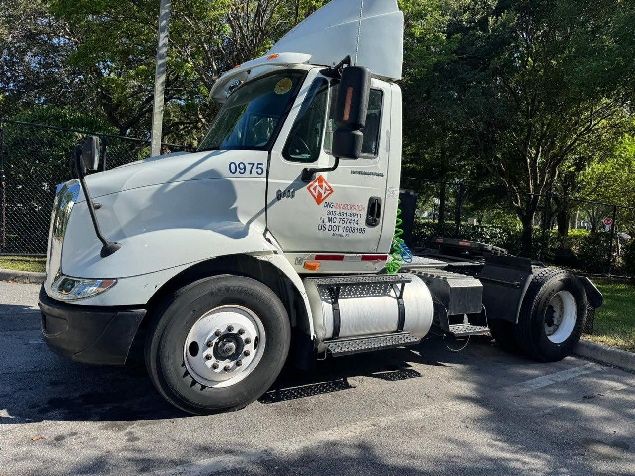 White semi-truck parked outdoors with a visible 