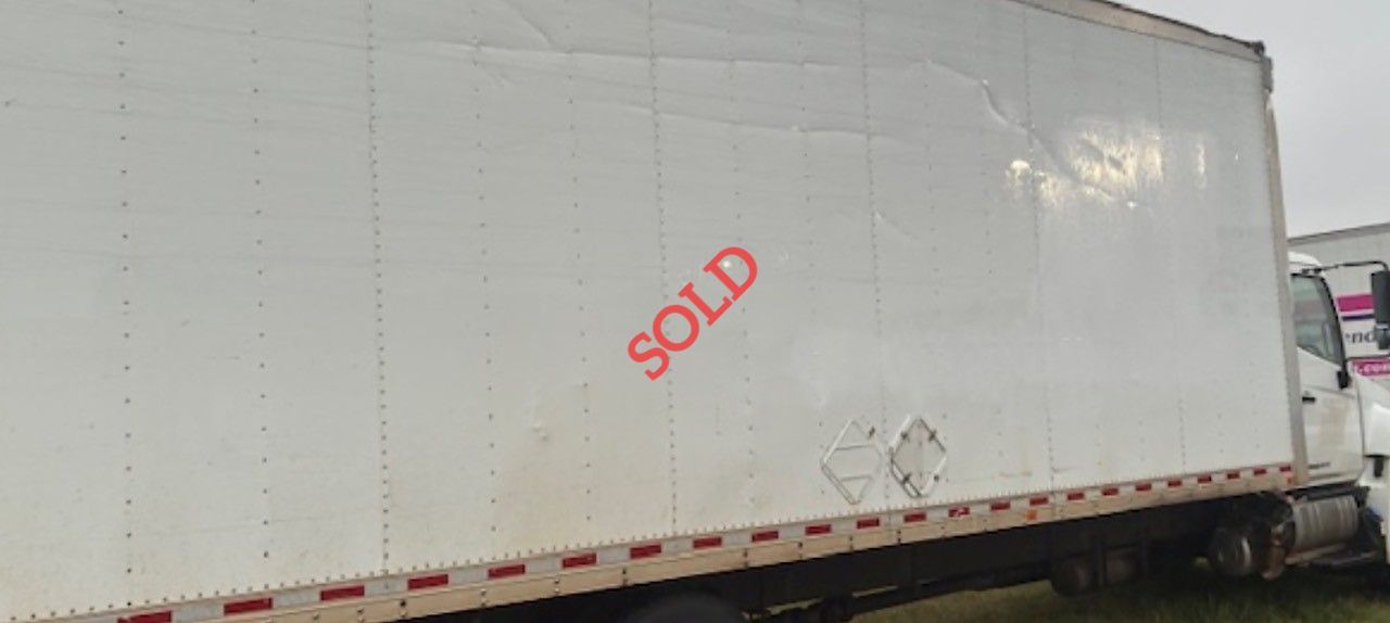 A white semi-trailer with the word 