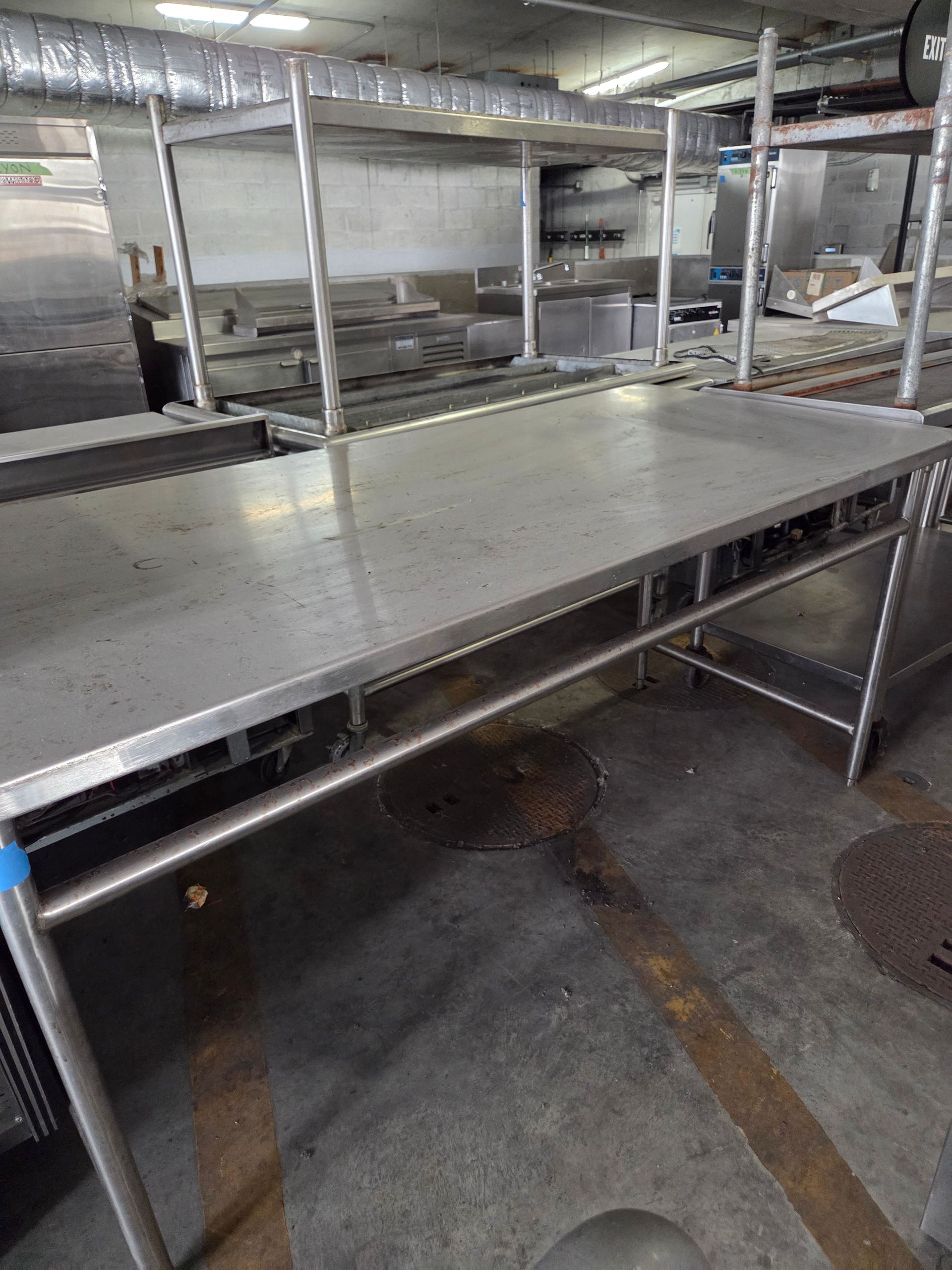 Stainless steel kitchen work table in a commercial kitchen.