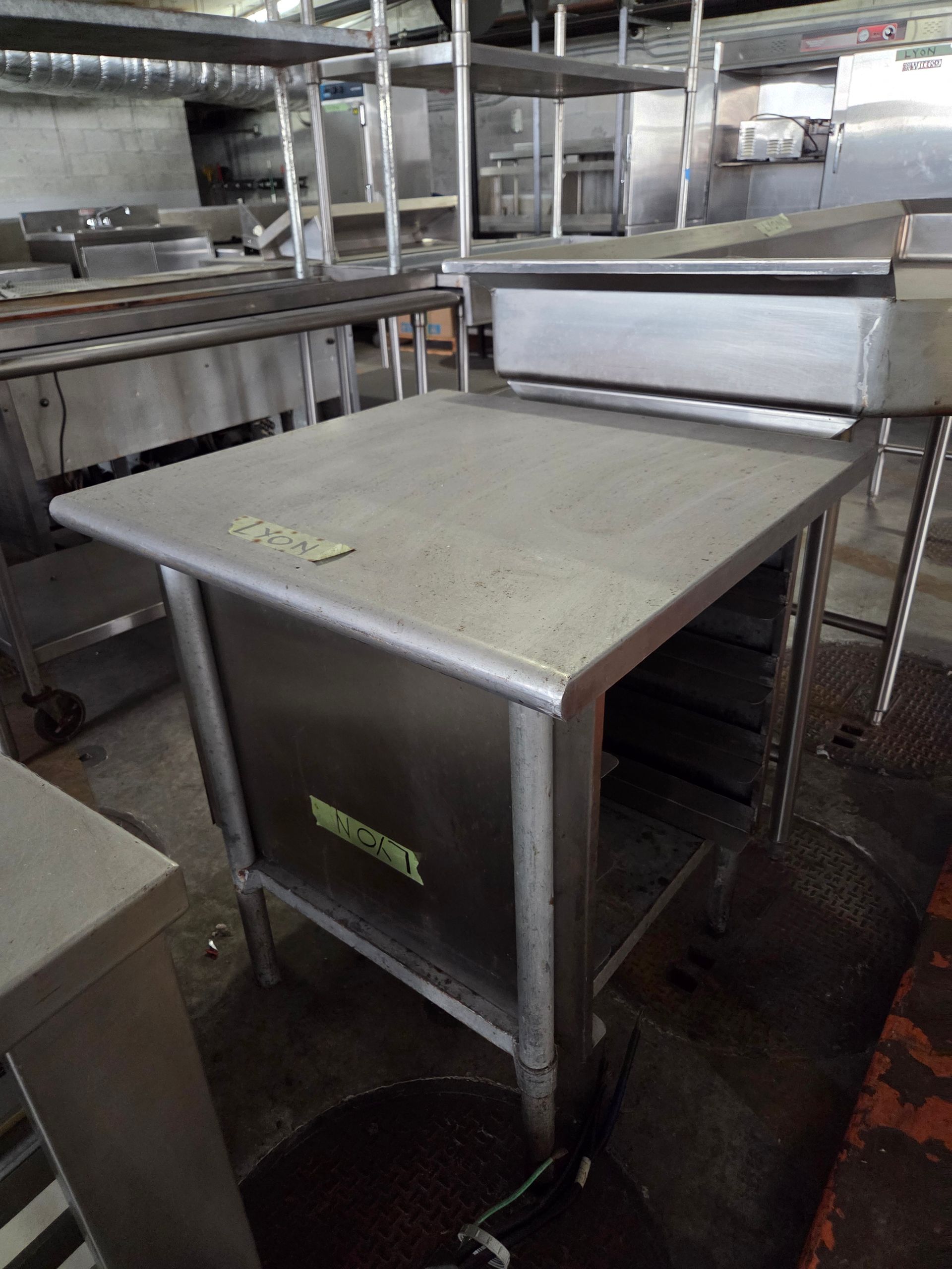 Stainless steel work table in a commercial kitchen.