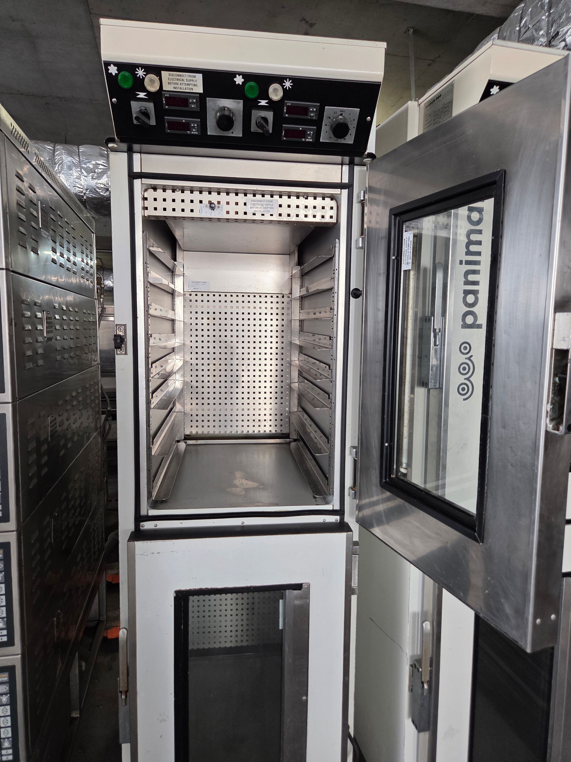 Open commercial oven with multiple shelves, controls above, and a side door.