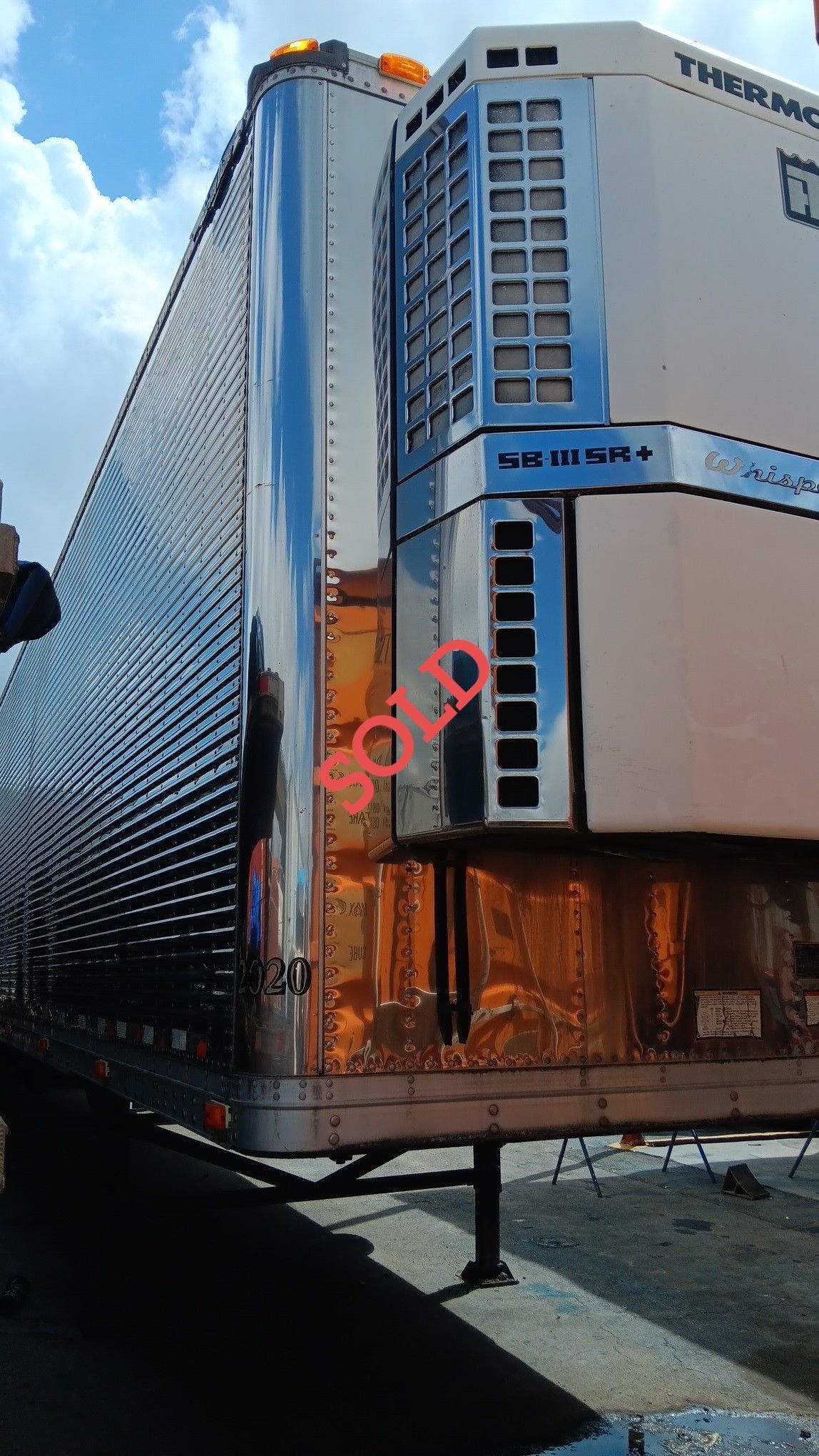 Silver refrigerated semi-trailer marked 