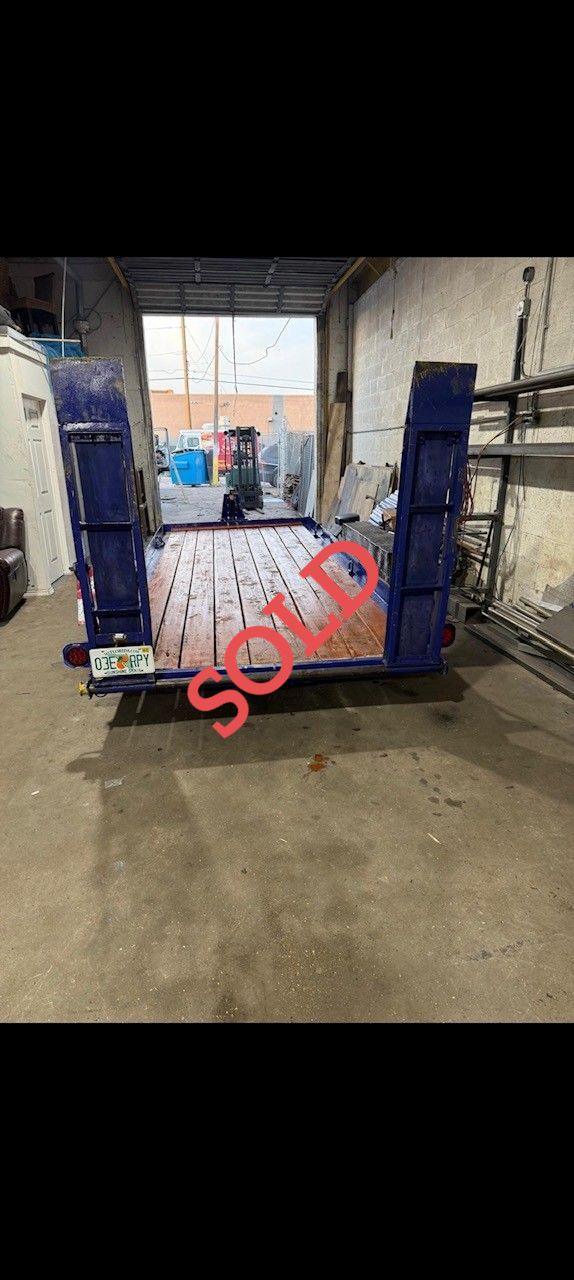 A large blue dumpster marked 