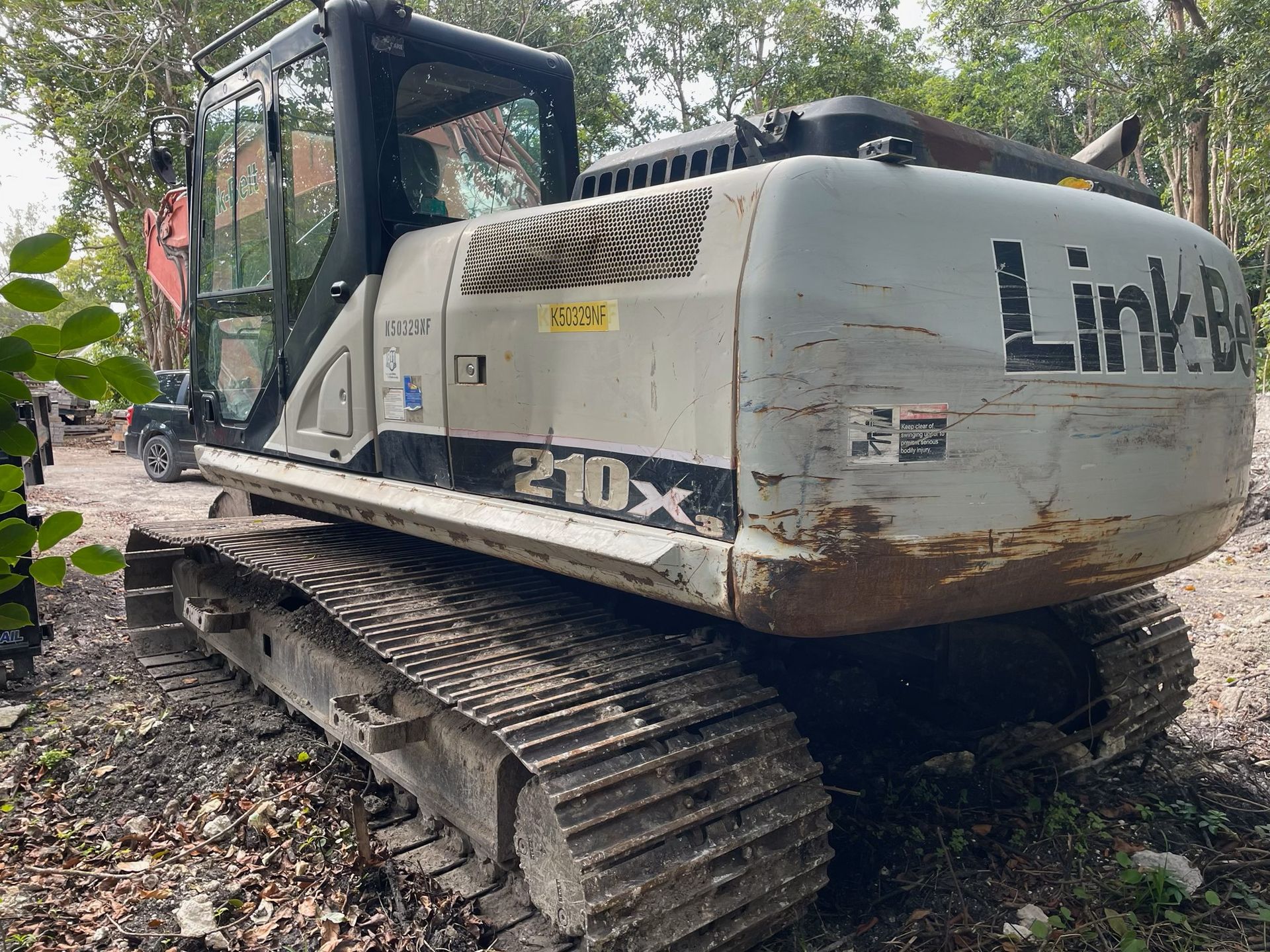 Gray Link-Belt 210X excavator on tracks in an outdoor setting.