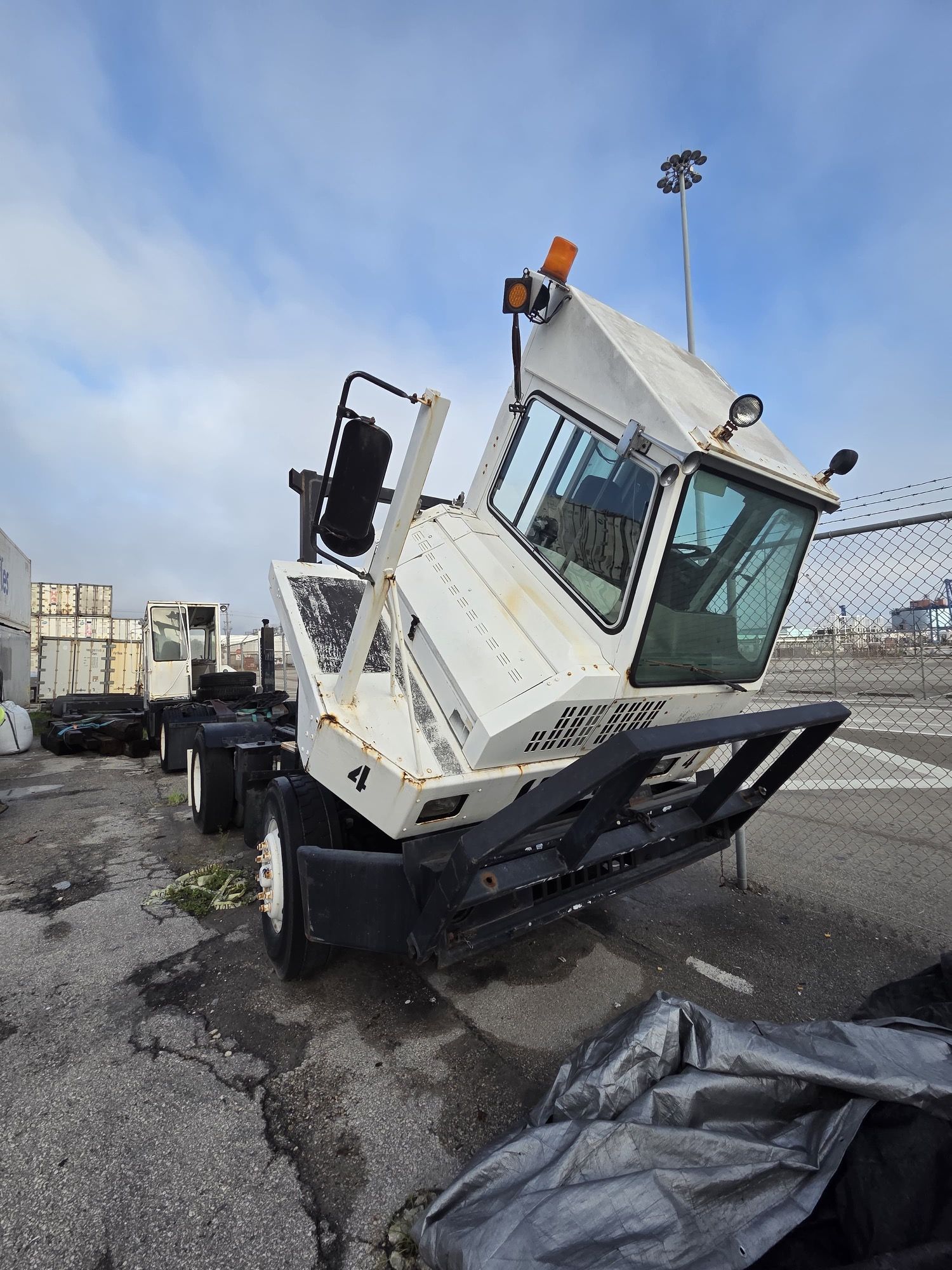 White yard truck with tilted cab, number 