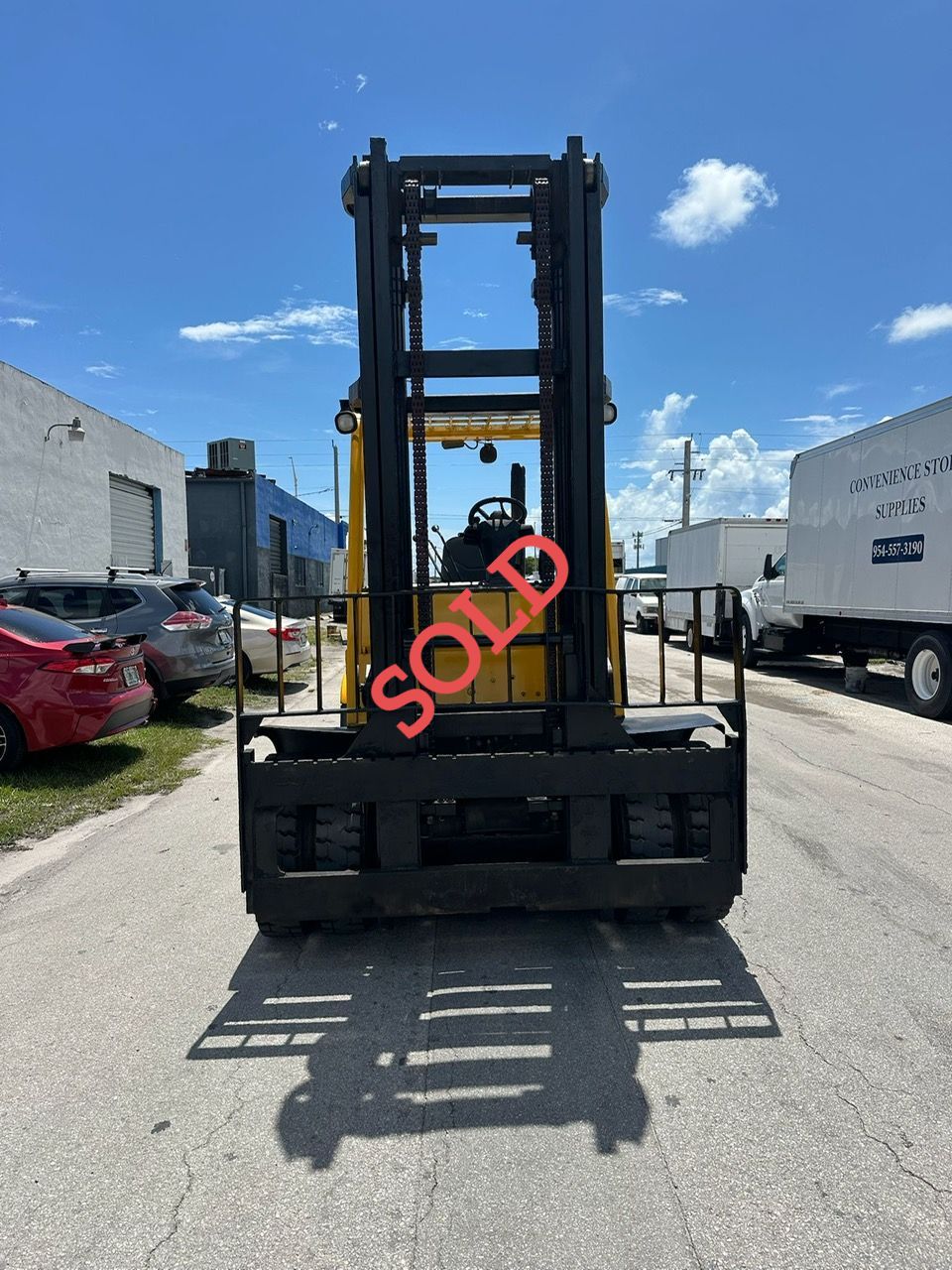 Yellow forklift, black forks, 