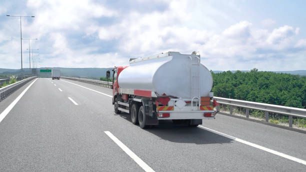 A tanker truck is driving down a highway.