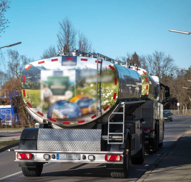 A tanker truck is parked on the side of the road