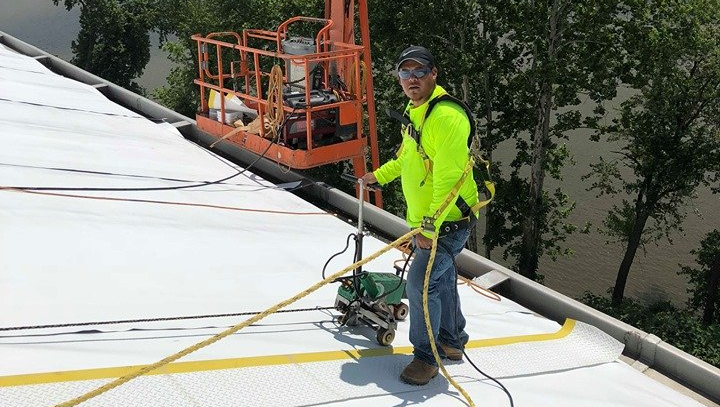 Man Repairing Roof — Warren, OH — Adrianna Construction & Roofing