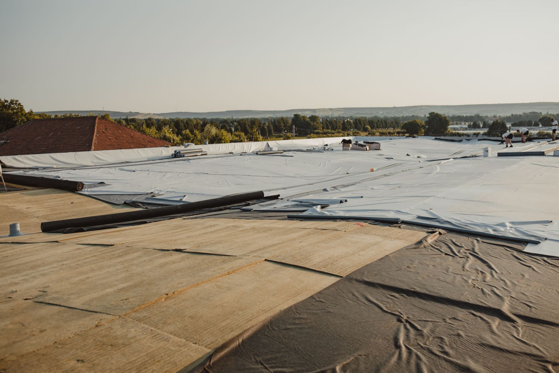 A large white roof is being installed on a building.
