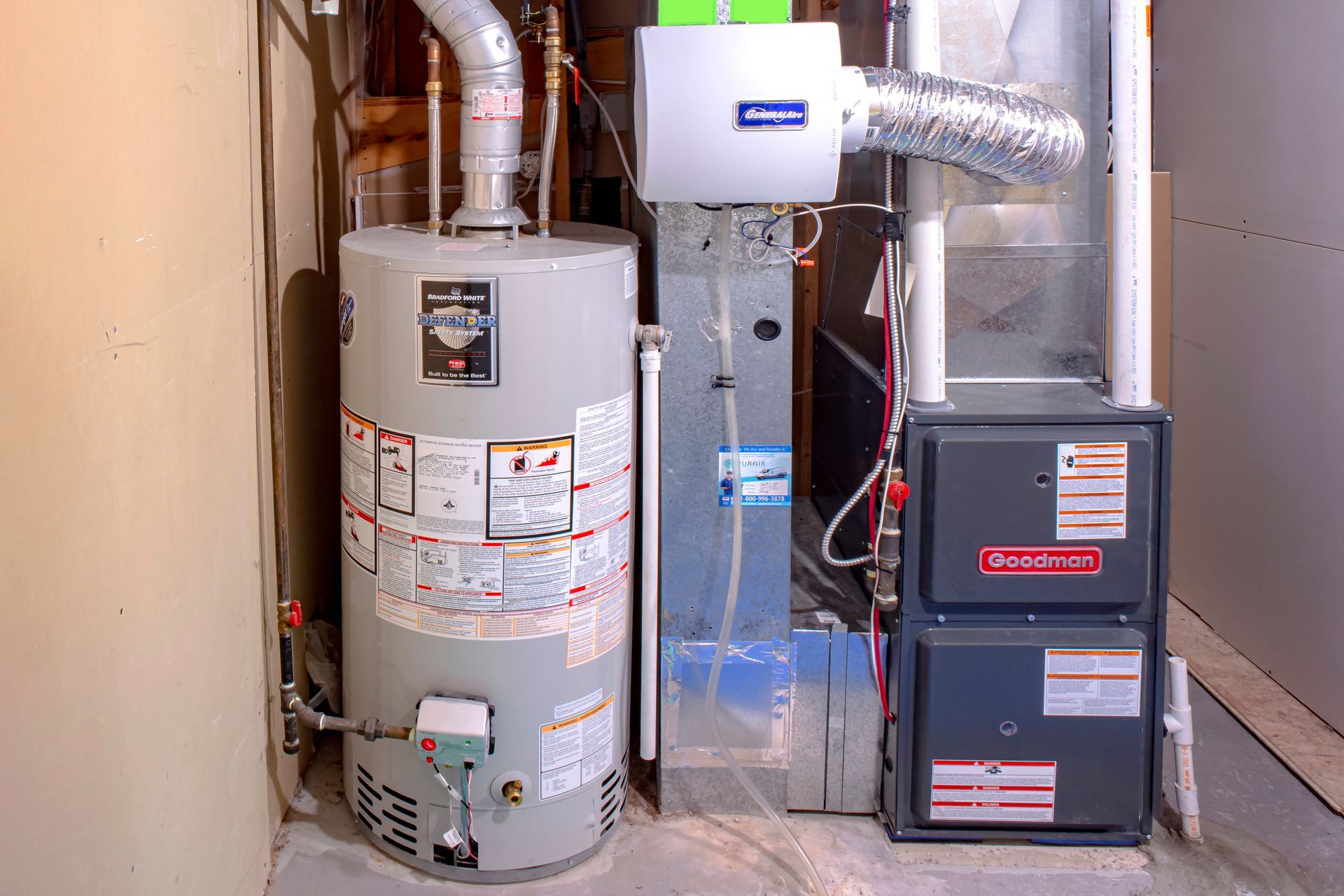 A water heater, humidifier, and furnace in a basement.