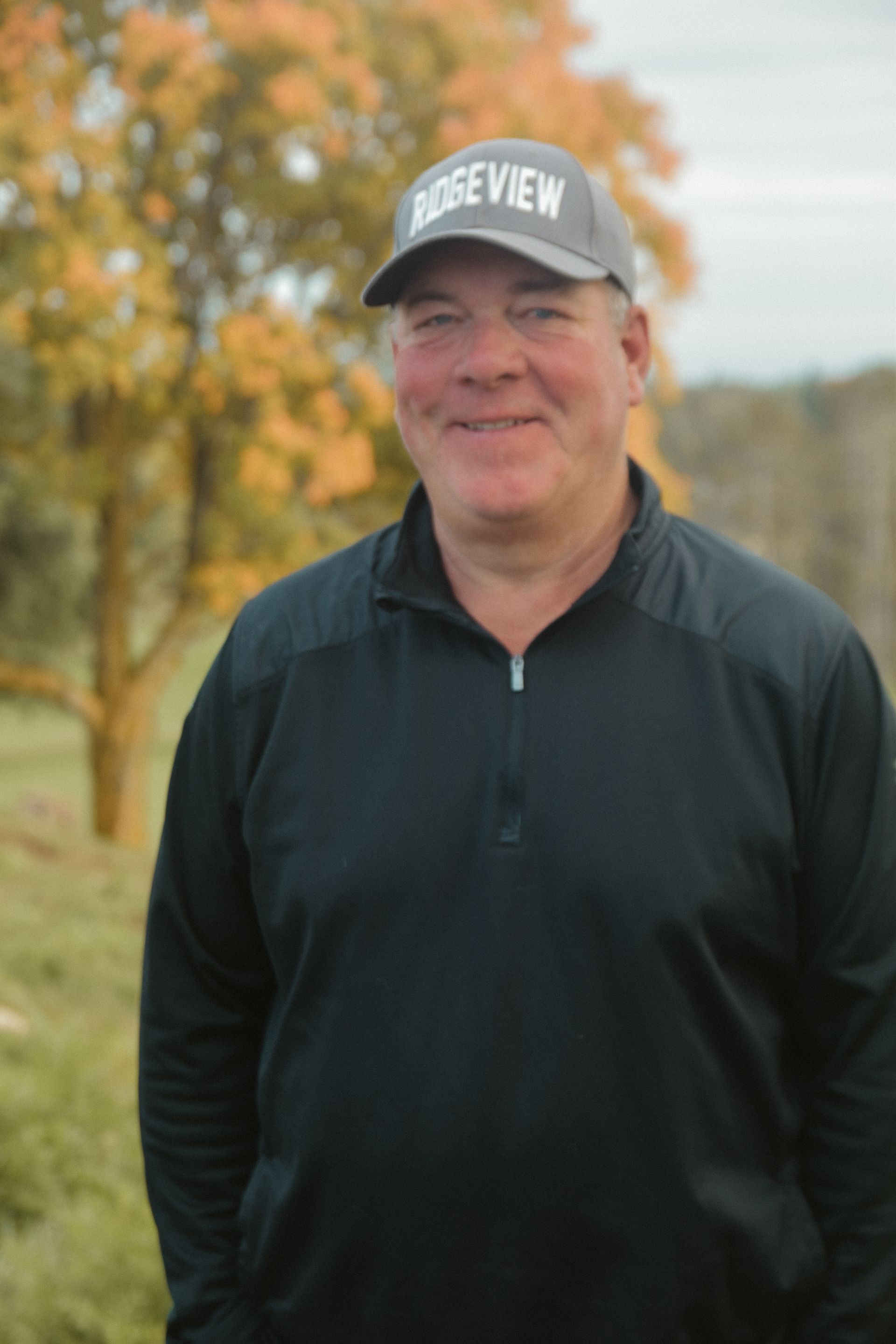 A man wearing a hat with the word ridgeview on it