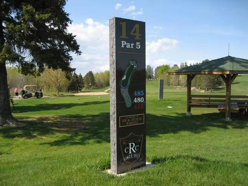 A golf course with a sign that says 14 par 5