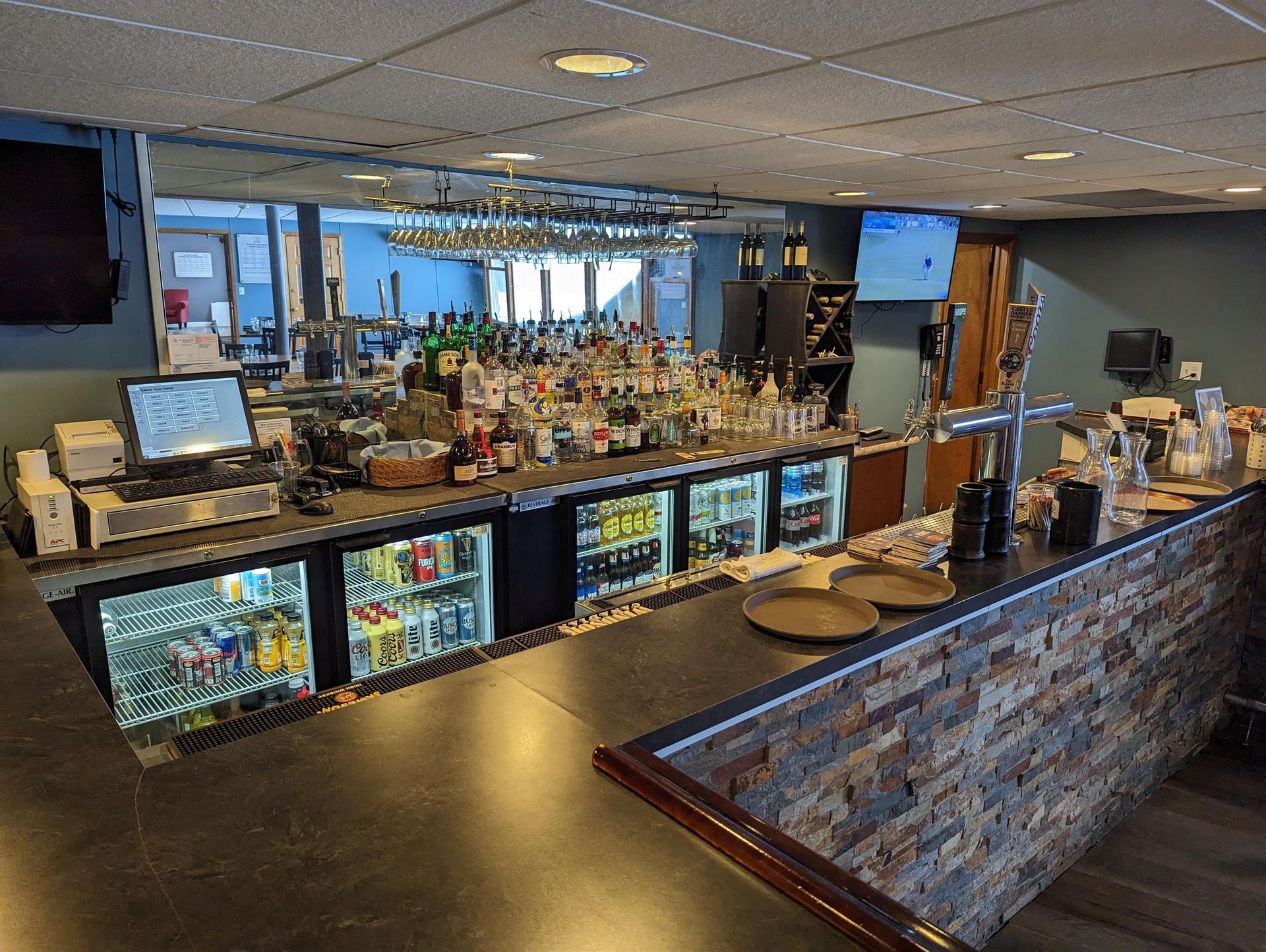 A bar with a lot of drinks and bottles on it