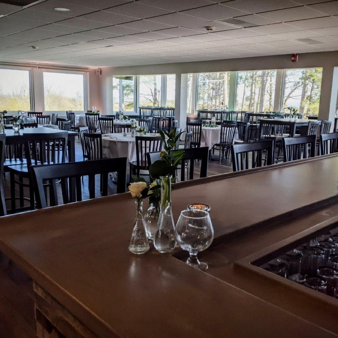 A restaurant with tables and chairs and a bar