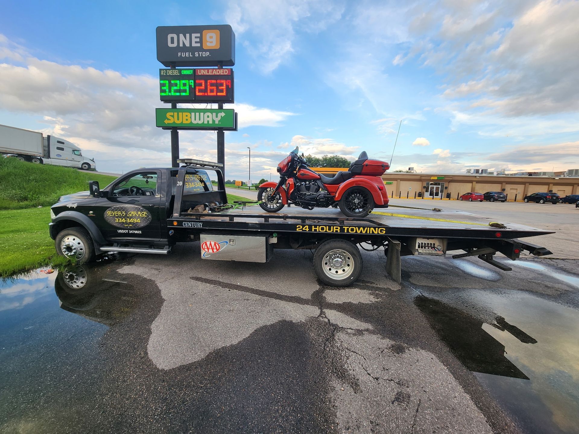tow truck with motorcycle on back | Seyer's Garage