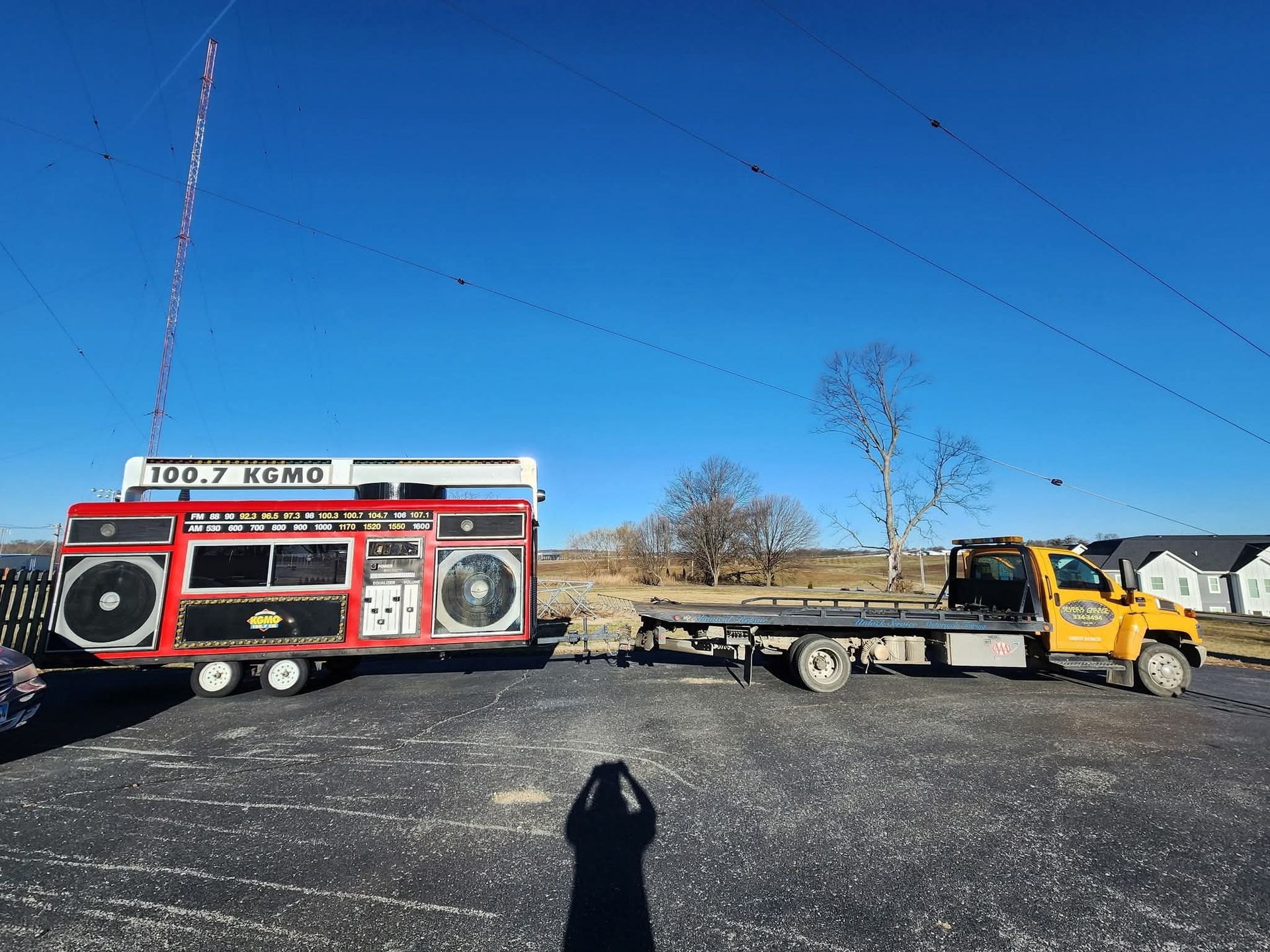 A tow truck is towing a trailer that looks like a boombox. | Seyer Garage