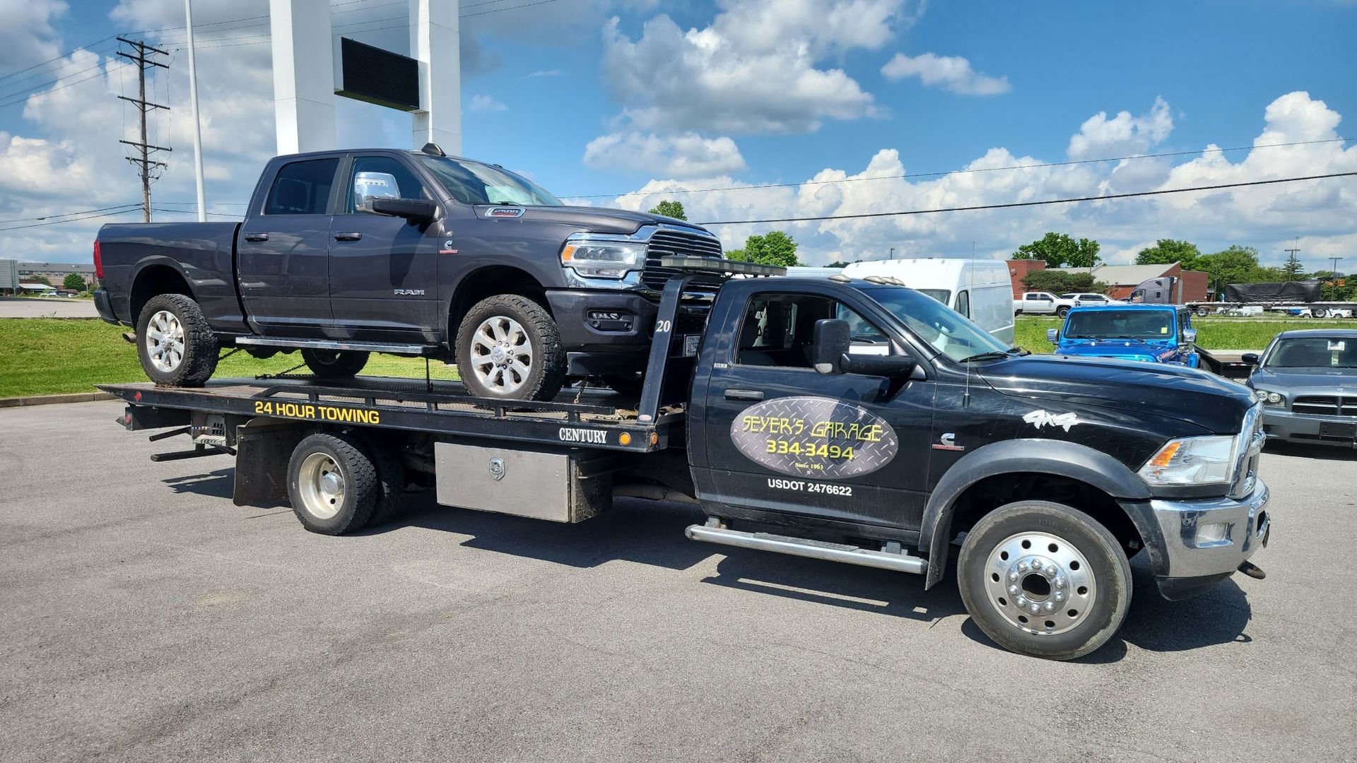 tow truck with truck on bed | Seyer's Garage