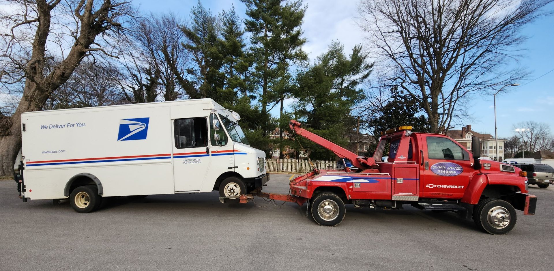 tow truck with USPS truck | Seyer's Garage