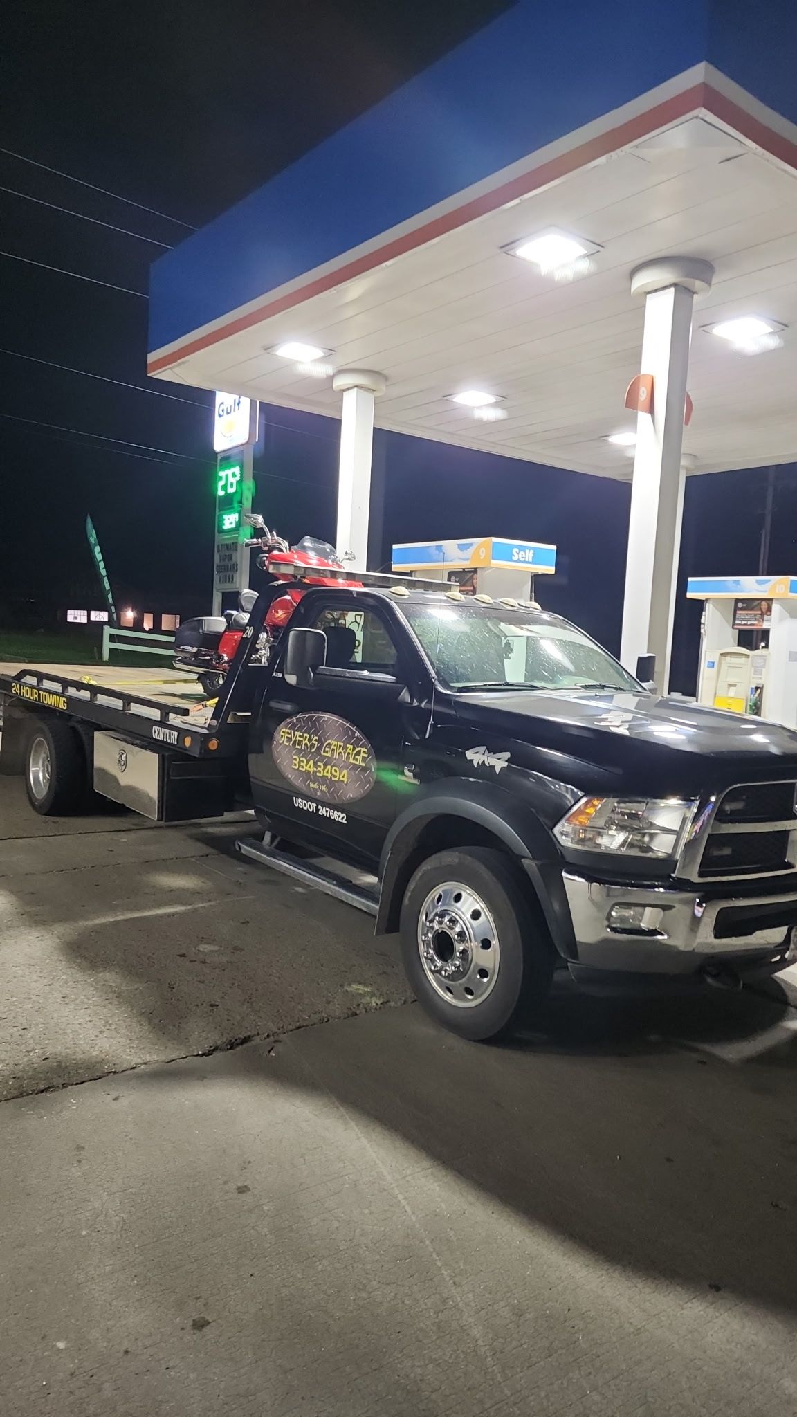 tow truck at a gas station | Seyer's Garage