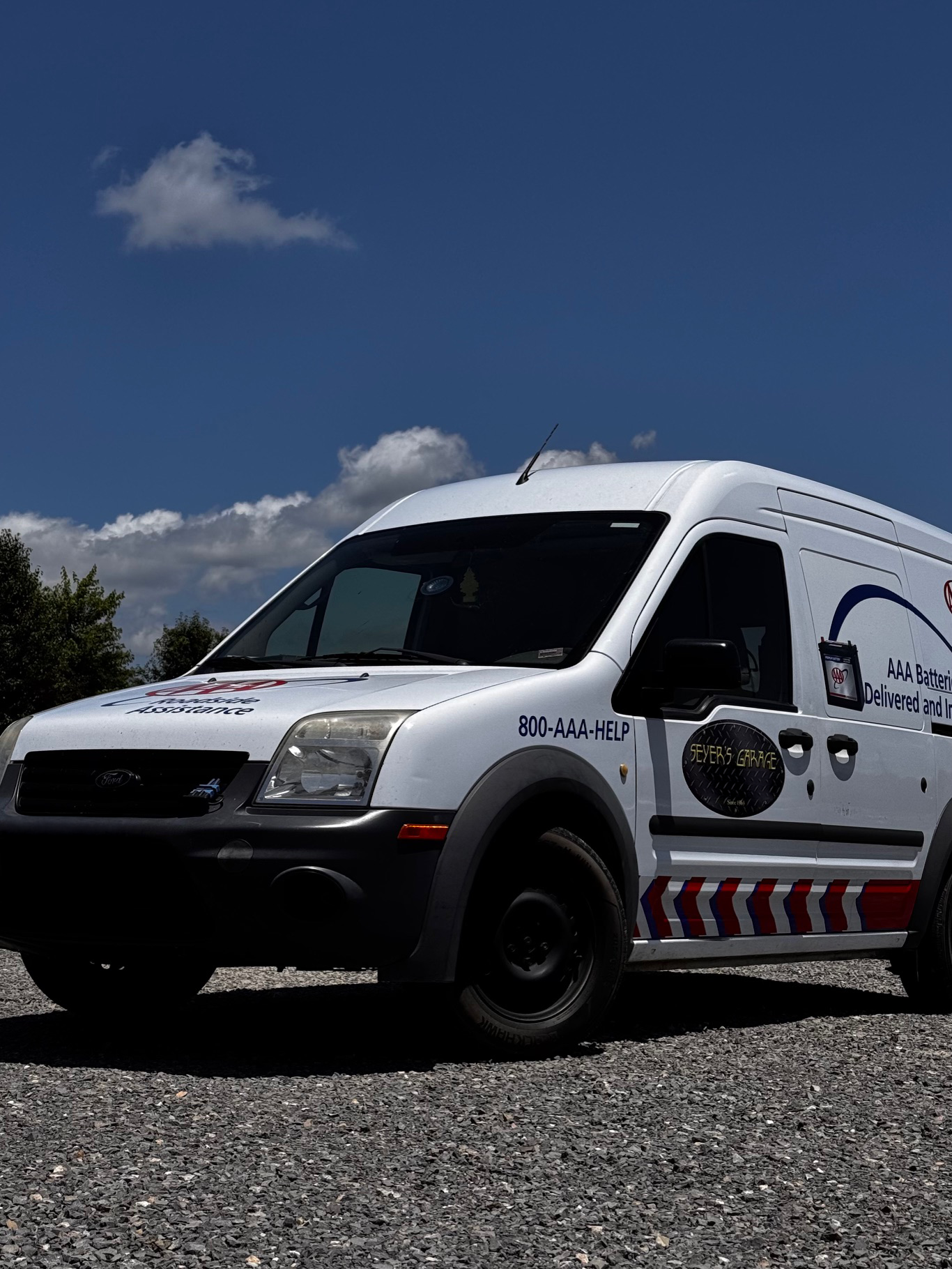 A white van is parked on a gravel road. | Seyer Garage